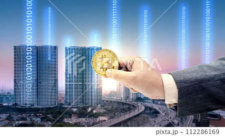 Business hand holding Bitcoin 112286169