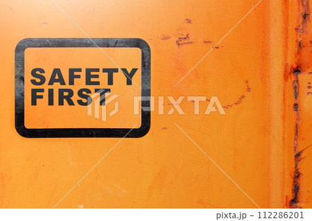 Text safety first on yellow background as a warning concept of industrial attention for employee awareness. 112286201
