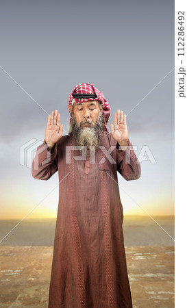 A Muslim man with agal in a praying position (salat) A Muslim man with agal in a praying position (salat) 112286492
