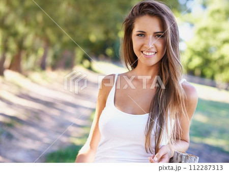Portrait, woman or smile for hair, fashion or summer in casual outfit with natural styling in park. Happy, female person and vest in sunlight for stylish, trendy and clothing in woods in Portugal Portrait, woman or smile for hair, fashion or summer in casual outfit with natural styling in park. Happy, female person and vest in sunlight for stylish, trendy and clothing in woods in Portugal 112287313