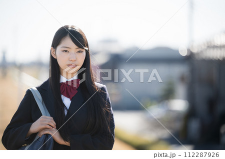 屋外で遠くを見るかわいい女子高生 正面 真剣な表情 屋外で遠くを見るかわいい女子高生 正面 真剣な表情 112287926