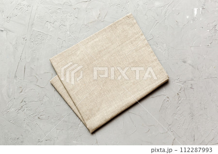 top view with gray kitchen napkin isolated on table background. Folded cloth for mockup with copy space, Flat lay. Minimal style top view with gray kitchen napkin isolated on table background. Folded cloth for mockup with copy space, Flat lay. Minimal style 112287993