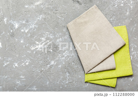 top view with gray kitchen napkin isolated on table background. Folded cloth for mockup with copy space, Flat lay. Minimal style top view with gray kitchen napkin isolated on table background. Folded cloth for mockup with copy space, Flat lay. Minimal style 112288000