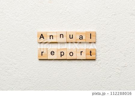 Annual report word written on wood block. Annual report text on cement table for your desing, concept 112288016