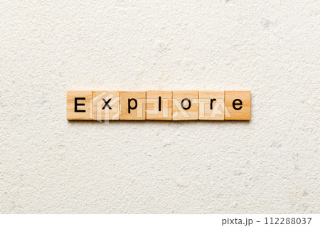 Explore word written on wood block. Explore text on cement table for your desing, concept Explore word written on wood block. Explore text on cement table for your desing, concept 112288037