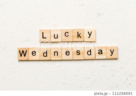 lucky wednesday word written on wood block. lucky wednesday text on cement table for your desing, concept lucky wednesday word written on wood block. lucky wednesday text on cement table for your desing, concept 112288091