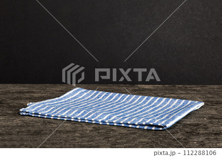 top view with blue kitchen napkin isolated on table background. Folded cloth for mockup with copy space, Flat lay. Minimal style 112288106