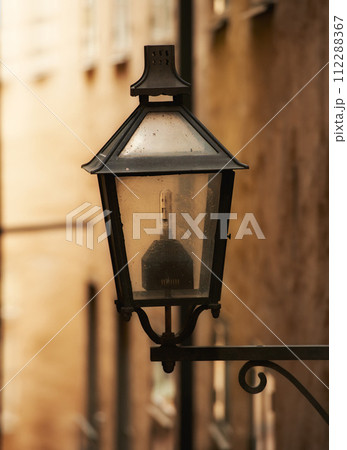 Travel, architecture and lamp on retro building in old town with history, culture or holiday destination in Sweden. Vacation, landmark and antique lantern in Stockholm with vintage light ancient city 112288367