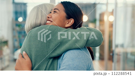 Senior woman, hug and old friend at a business office with a smile, support and excited. Elderly person, love and happy women together at a workplace with care from staff at physiotherapy with health 112288541
