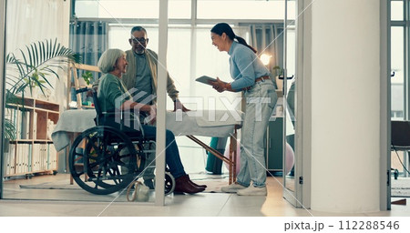 Senior, physiotherapy and couple with doctor and tablet for a consultation and person with disability. Rehabilitation, patient and woman speaking to a physiotherapist with tech for medical advice 112288546