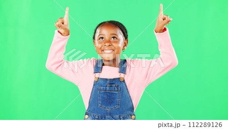 Kids, pointing and a black girl on a green screen background in studio for marketing a product. Children, portrait and advertising with a cute little female child showing space on chromakey mockup Kids, pointing and a black girl on a green screen background in studio for marketing a product. Children, portrait and advertising with a cute little female child showing space on chromakey mockup 112289126