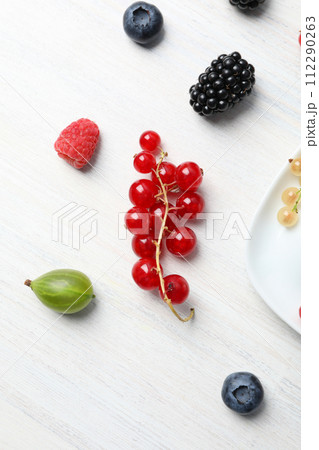 Ripe berries on the table on a light background. Ripe berries on the table on a light background. 112290263