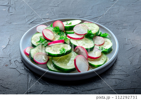 Fresh cucumber and radish salad with parsley. Simple vegan recipe 112292731