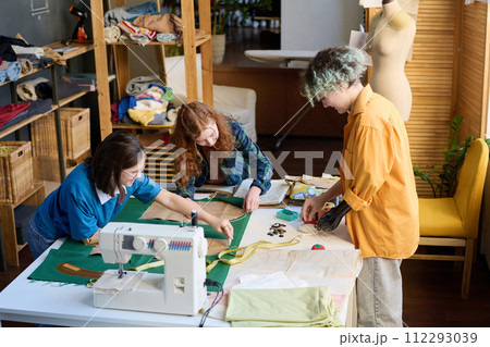 High angle view at diverse group of girls sewing clothes together in inclusive school 112293039