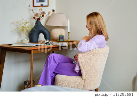 A beautiful model is sitting reading and looking at a magazine. The concept of learning, spending time with benefits 112293681