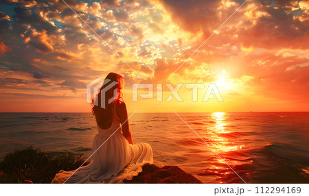 Young Woman Watching Sunset in a Beach in a Romantic Style Young Woman Watching Sunset in a Beach in a Romantic Style 112294169