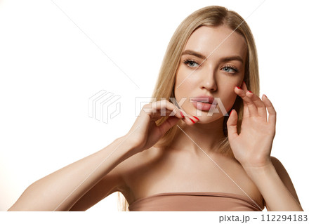 Portrait of young beautiful blonde woman with perfect smooth skin isolated over white background. Tenderness and sensuality. Portrait of young beautiful blonde woman with perfect smooth skin isolated over white background. Tenderness and sensuality. 112294183