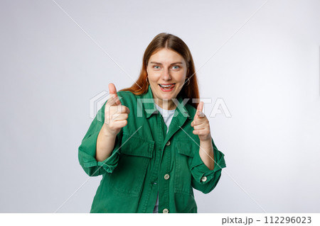 Young smiling happy fun woman point index finger camera on you say do it motivate isolated on white background, studio portrait. Looking at the camera and smiling Young smiling happy fun woman point index finger camera on you say do it motivate isolated on white background, studio portrait. Looking at the camera and smiling 112296023