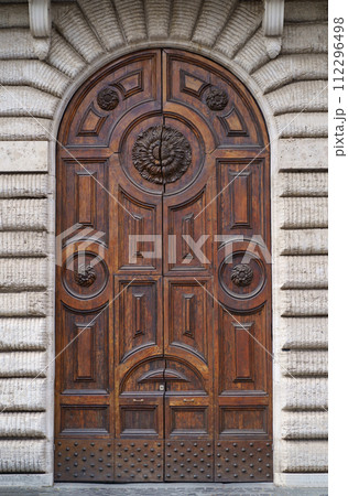 doors of Rome. Classic old wooden door in a public place on a city street or in an urban environment 112296498