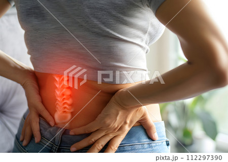 AI-generated content. Close-up of woman suffering from back pain at home, concept of healthcare 112297390