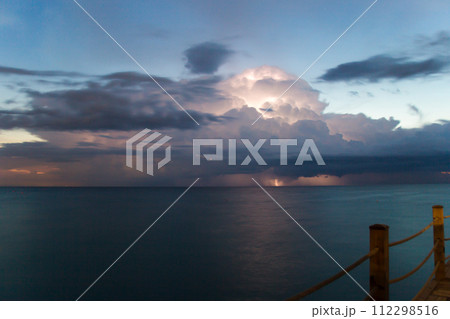 Thunderstorm with lightning in the sky over the pier in the early morning 112298516