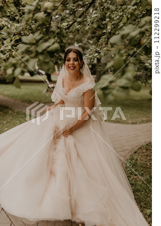 Caucasian young woman bride spinning whirls dancing posing moving at nature 112299218