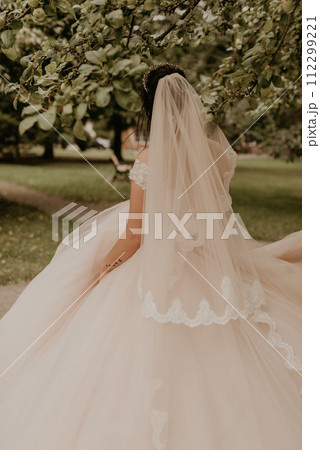 Caucasian young woman bride spinning whirls dancing posing moving at nature Caucasian young woman bride spinning whirls dancing posing moving at nature 112299221