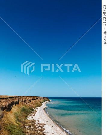 cliff sea blue aquamarine waves line sunny beach. Soft wave of ocean foam. cliff sea blue aquamarine waves line sunny beach. Soft wave of ocean foam. 112299728