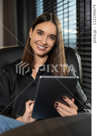 Cute young business woman with a tablet in hands 112299874