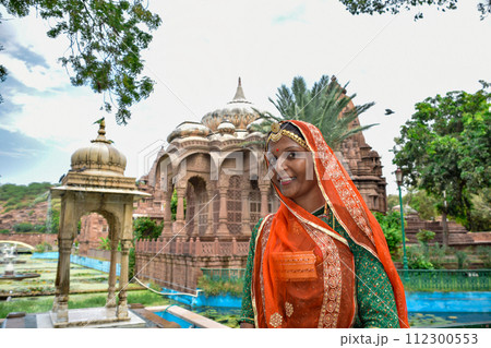 Indian Woman with beautiful face posing with textiles in background 112300553