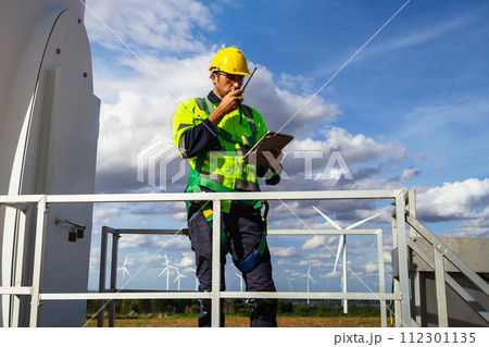 engineers are discussing maintenance of wind turbines. Clean energy. Alternative energy concept engineers are discussing maintenance of wind turbines. Clean energy. Alternative energy concept 112301135