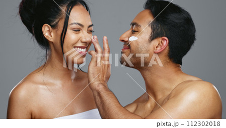 Couple, smile and love for skincare, care and portrait with moisturizer in studio by gray background. Happy people, dermatology and hug for cosmetics, hydration and creme or love for skin treatment 112302018