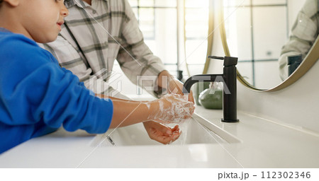 Woman, child and washing hands in bathroom, cleaning to prevent germs and dirt in home with soap, water and hygiene. Kid, mom and hand wash, teaching, learning and clean morning routine with family. 112302346