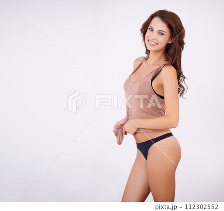 Portrait, body and happy woman in underwear in studio for wellness, confidence or care on grey background. Face, smile or model in lingerie with results satisfaction from diet, detox or glowing skin Portrait, body and happy woman in underwear in studio for wellness, confidence or care on grey background. Face, smile or model in lingerie with results satisfaction from diet, detox or glowing skin 112302552