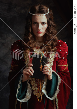 medieval queen in red dress with book and rosary medieval queen in red dress with book and rosary 112303549
