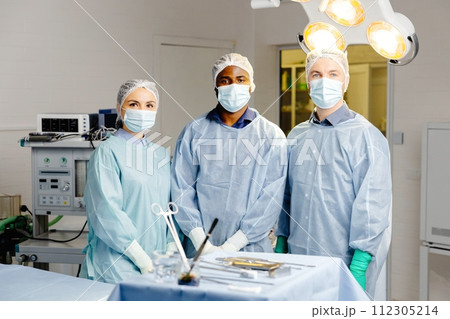 Group of doctors discussing patient cases around table Group of doctors discussing patient cases around table 112305214