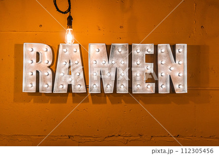 Neon lights that have the word ramen written on an orange background. 112305456