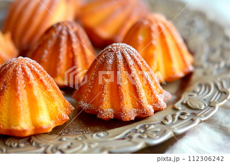 Classic French madeleine cookies, buttery and delicate, mini sponge cake baked in scallop mold Classic French madeleine cookies, buttery and delicate, mini sponge cake baked in scallop mold 112306242
