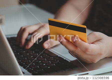 Credit card payment. Woman hands holding credit card and using laptop. Online shopping 112306596
