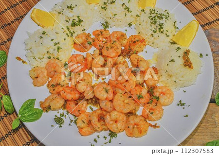 Grilled prawns and cooked rice with slices of lemon and chopped basil. Food photography. Bio healthy recipe 112307583