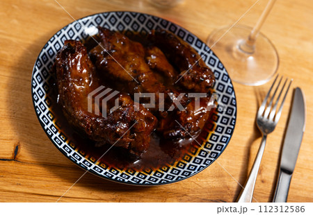 Appetizing delicious fried pork ribs on plate. Nutritious lunch 112312586
