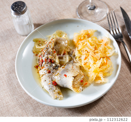 Sliced herring served with sauerkraut Sliced herring served with sauerkraut 112312622
