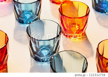 AI-generated content. Colorful empty glasses on white. Light and shadow, different shapes and color 112312738