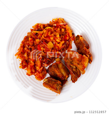 Delicious pork ribs in gravy with barley and cabbage stewed close up 112312857