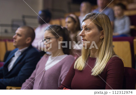 portrait of female caucasian viewer sitting at premiere in theatrical hall 112312974