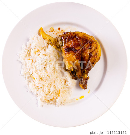 Tasty chicken thighs with rice and parsley at plate on table 112313121