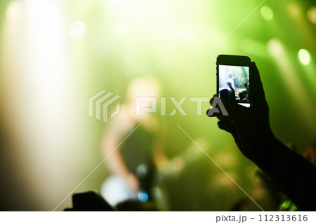 Nightclub, festival and audience with phone or lights for music, party and rave concert with silhouette and band. Disco, psychedelic event and performance with entertainment, crowd and smartphone 112313616