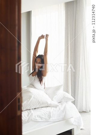 Bedroom, woman and stretching in bed at house, home and hotel for sleeping, morning and wake up refreshed in Cape Town. Female person, lady and happy for weekend, rest and comfortable from nap Bedroom, woman and stretching in bed at house, home and hotel for sleeping, morning and wake up refreshed in Cape Town. Female person, lady and happy for weekend, rest and comfortable from nap 112314740
