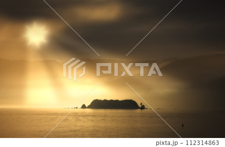 Ocean, sunset and clouds in evening with mountains, water and waves in lake. Travel, destination and vacation for summer beach or island, landscape and environment for holiday journey with sunshine Ocean, sunset and clouds in evening with mountains, water and waves in lake. Travel, destination and vacation for summer beach or island, landscape and environment for holiday journey with sunshine 112314863