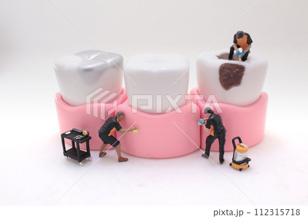 miniature workers clean and correct the tooth model miniature workers clean and correct the tooth model 112315718